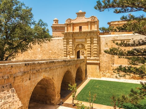 Historische stenen poort en brugingang naar de ommuurde stad Mdina, Malta.
