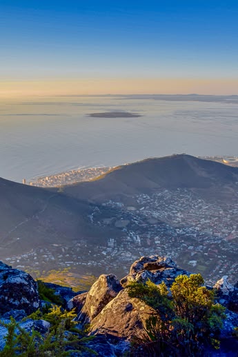 Panoramisch uitzicht op Kaapstad, Zuid-Afrika, vanaf de Tafelberg met Lion's Head en de kustlijn eronder bij zonsopgang.
